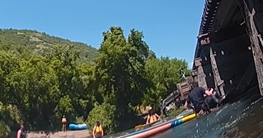 Watch: People rush to save paddleboarder trapped under Utah bridge
