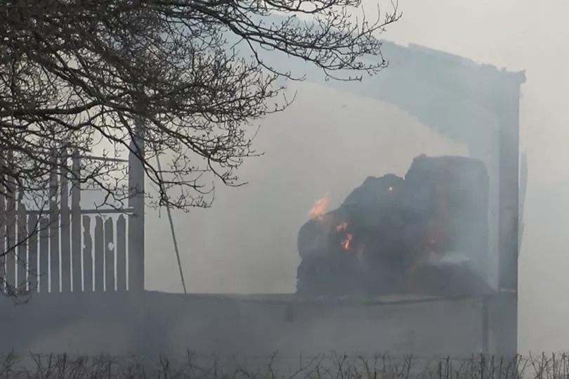 Barn 'fully engulfed' as crews tackle fire