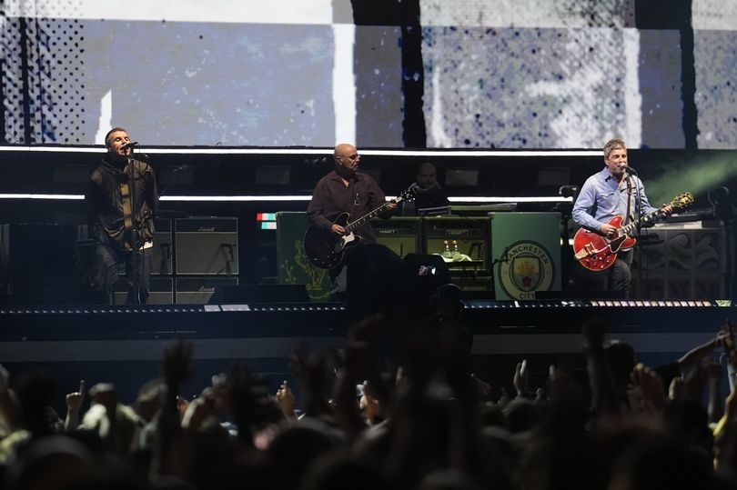 First picture of Liam and Noel together as Oasis finally reunite at Cardiff Principality Stadium