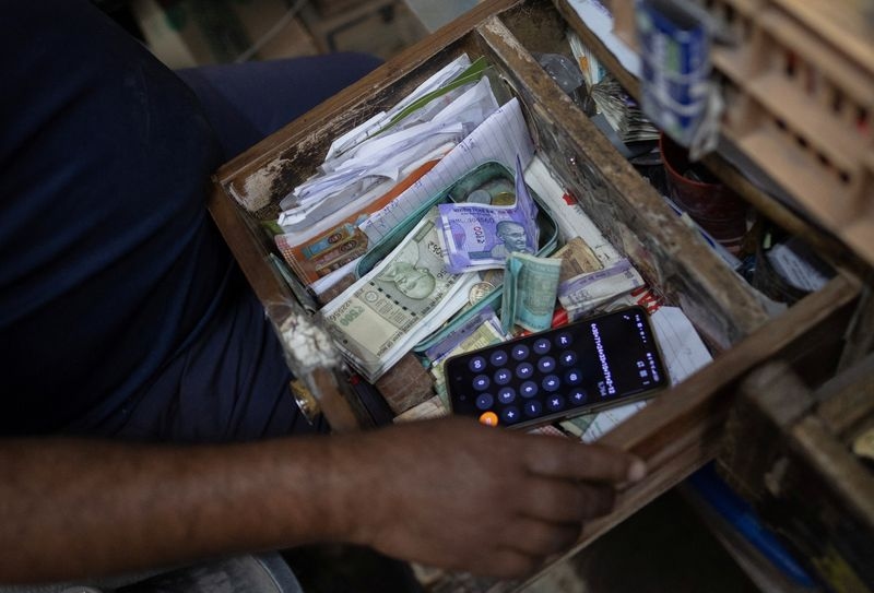 Rupee slips but sidesteps firmer dollar as flows dominate price-action
