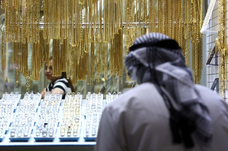 Gold rises as weaker dollar, Trump's Powell criticism fuel uncertainty