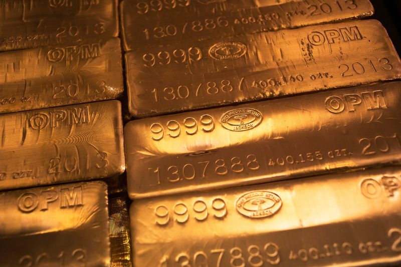 Gold poised for weekly gain on dollar weakness, safe-haven demand