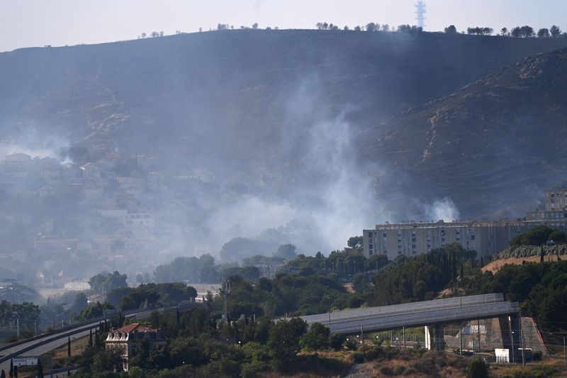 Firefighters battle wildfire threatening French city of Marseille