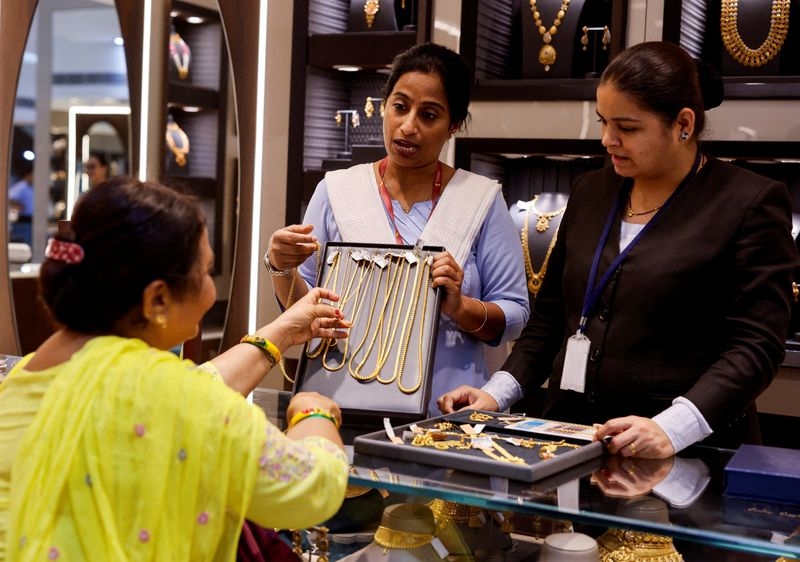 Gold firms on weaker dollar and US tariffs, fiscal uncertainty