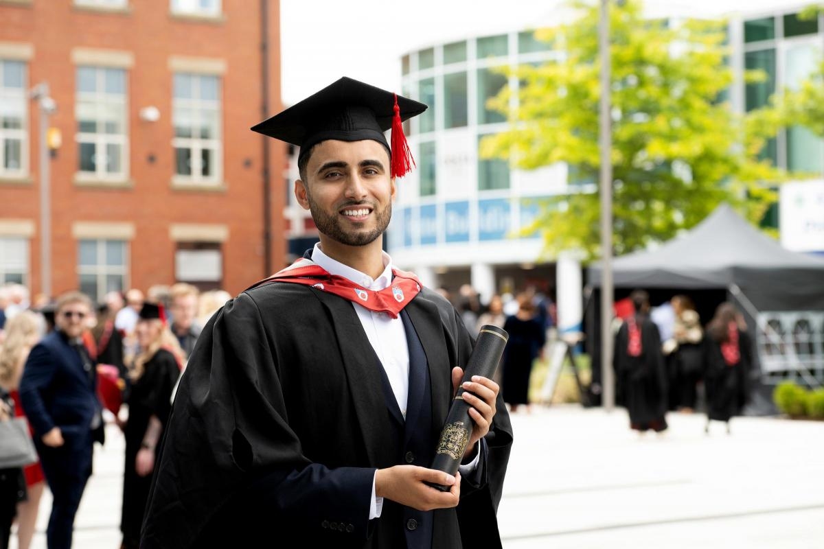 Student's determination pays off as he achieves his ambition on graduation day