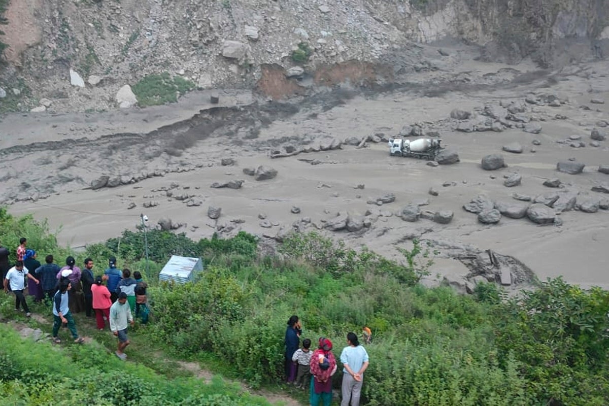 Floods sweep away 18 people and bridge linking Nepal to China