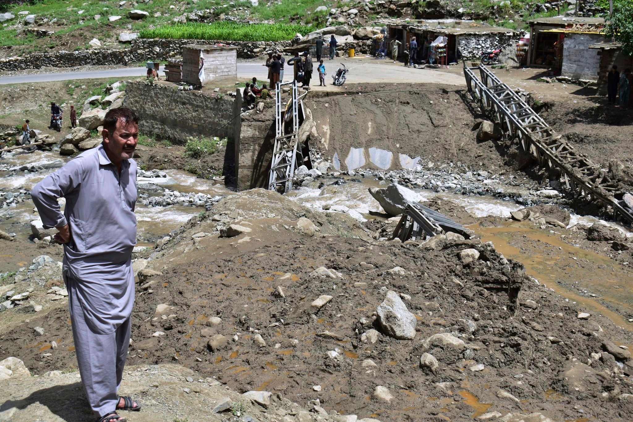 Rescuers expand search in northern Pakistan for 12 missing tourists swept away by floods