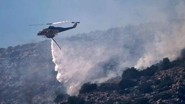 Firefighting helicopter crashes into sea trying to collect water as wildfires burn across Greece