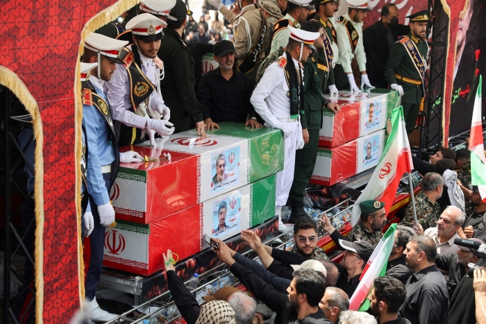 Iran holds funeral for slain commanders and scientists