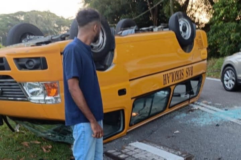 Sixteen primary and secondary students hospitalised for broken bones after school bus flips over JB pothole