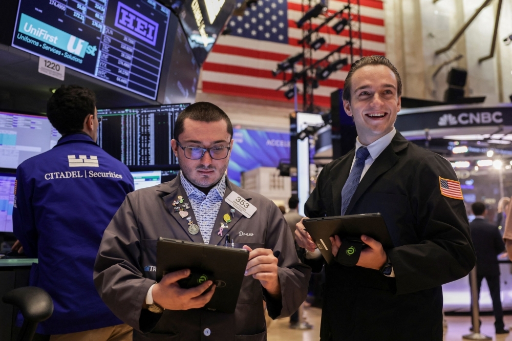 Wall Street hits records as investors bet on more trade deals, but global markets lag