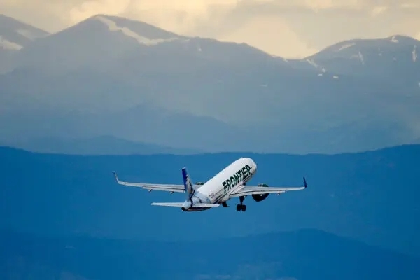 Passengers restrain a man who bashed a flight window