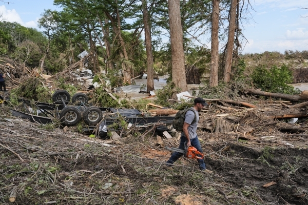 Rescuers on horseback, with dogs search for Texas flood victims
