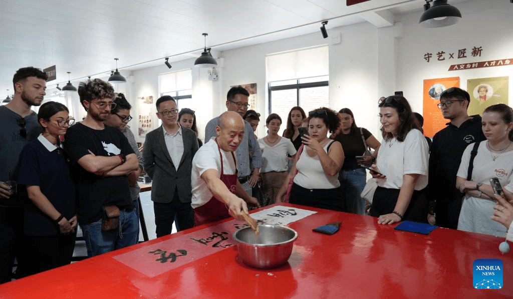 A Chinese cultural guardian holds heritage in his hands